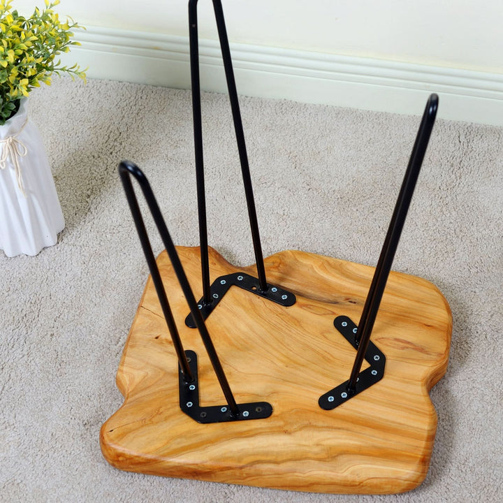 Natural edge solid wood side table by Blak Hom with black hairpin legs.
