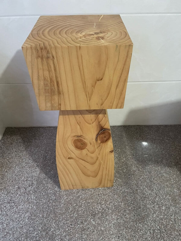 Set of 4 natural solid wood kitchen stools with visible wood grain and knots on speckled floor.