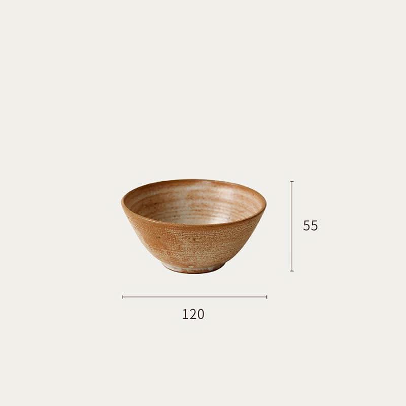 Handmade brown clay bowl, part of a rustic tableware set. Home decor.