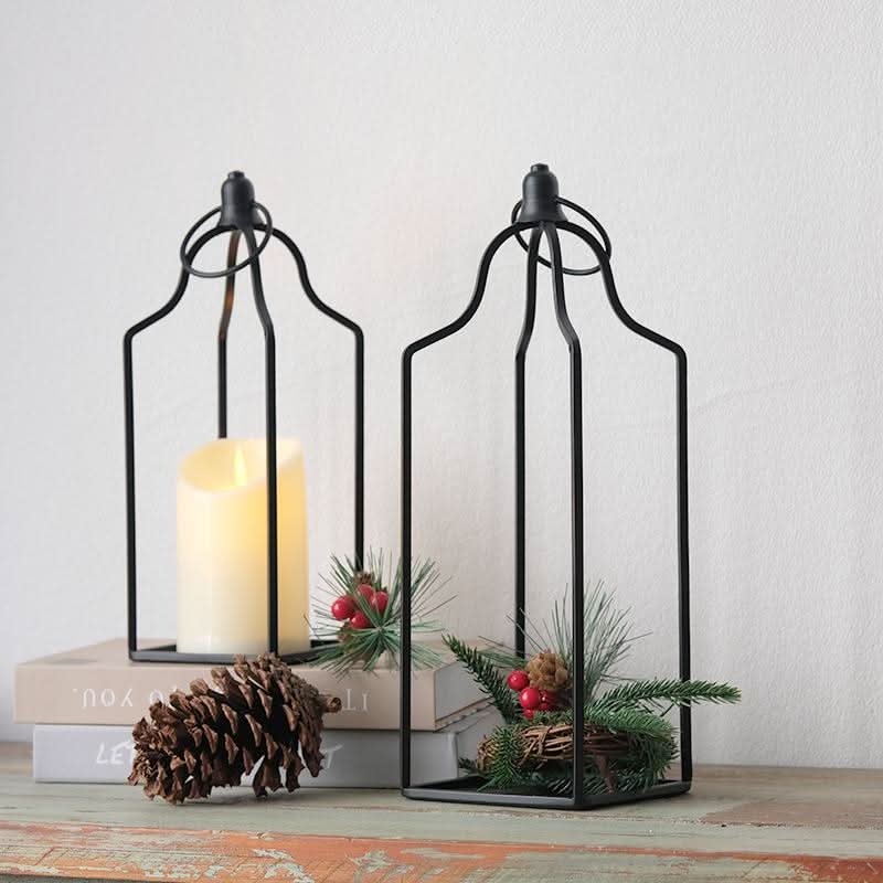 Black metal line candle holder set of 2 with festive pine accents.