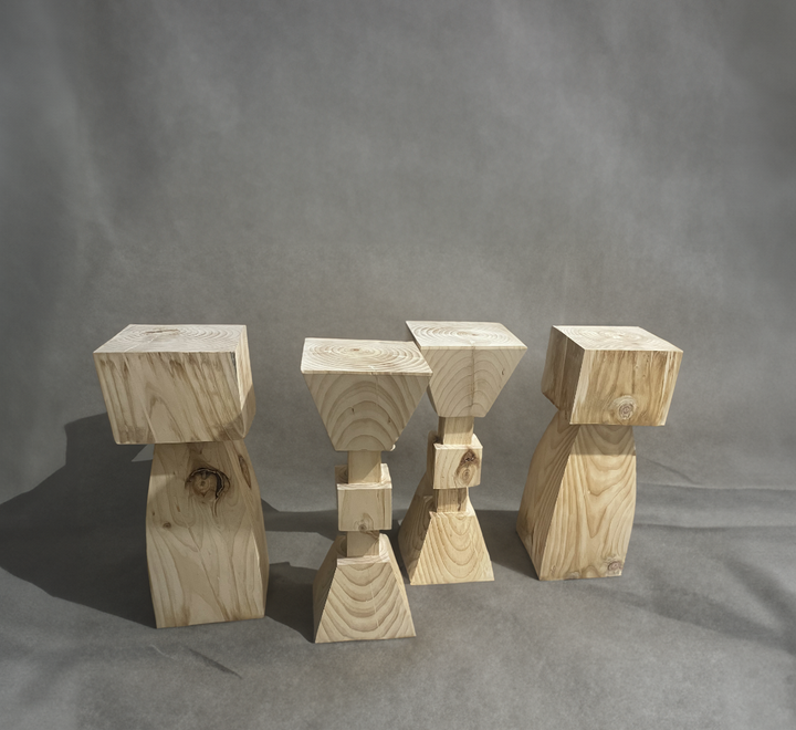 Set of 4 solid wood kitchen stools, natural wood finish, on gray backdrop.