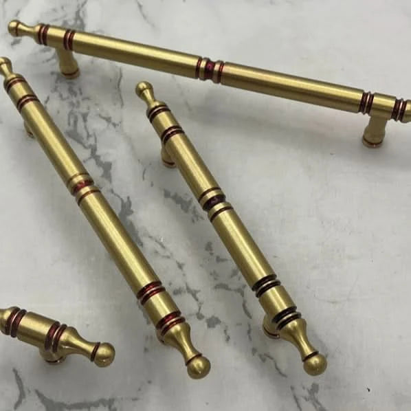 Solid Brass Cabinet Handles - Classic Style with red accents on marble background