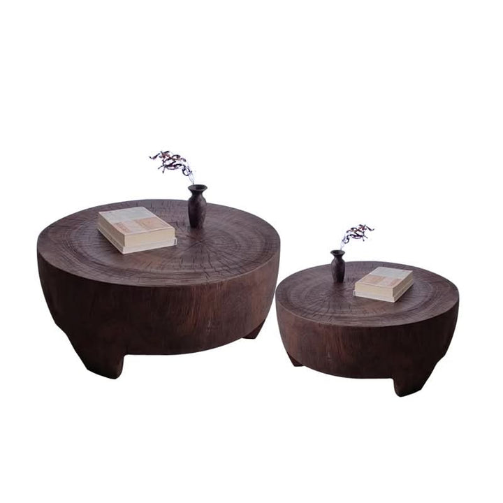 Raw wood coffee table, rustic brown, unique design, with books and vase on top.