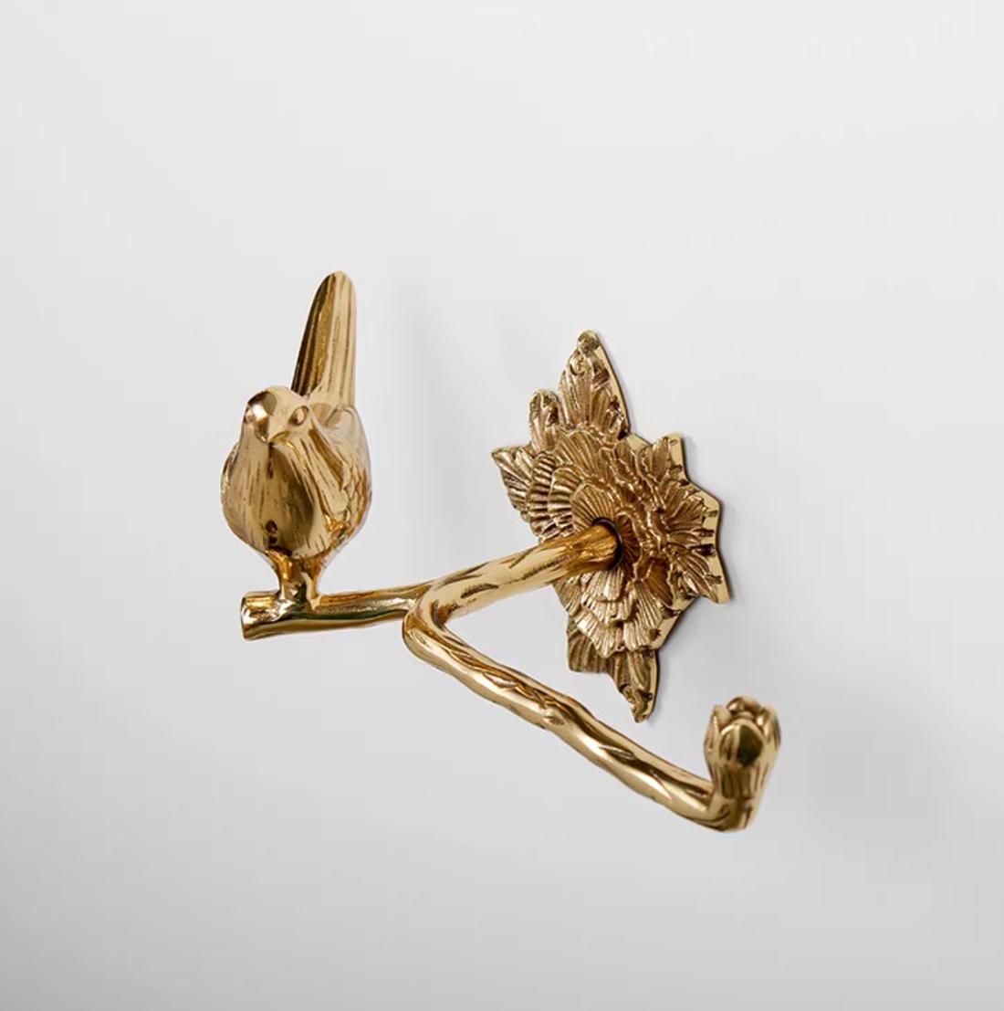 Gold brass bird bathroom set toilet paper holder with decorative floral mount.