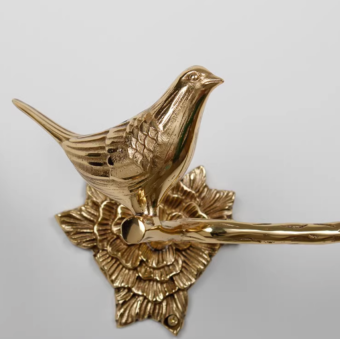 Brass bird bathroom set towel rack and toilet paper holder with floral base.