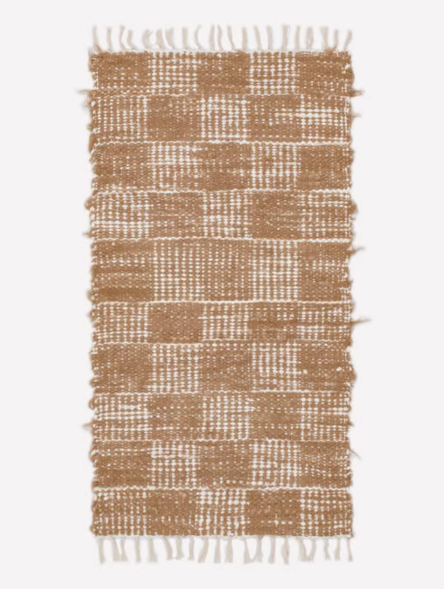 Handwoven cotton checkered rug 2.3x4.6 in brown and white, with fringed edges.
