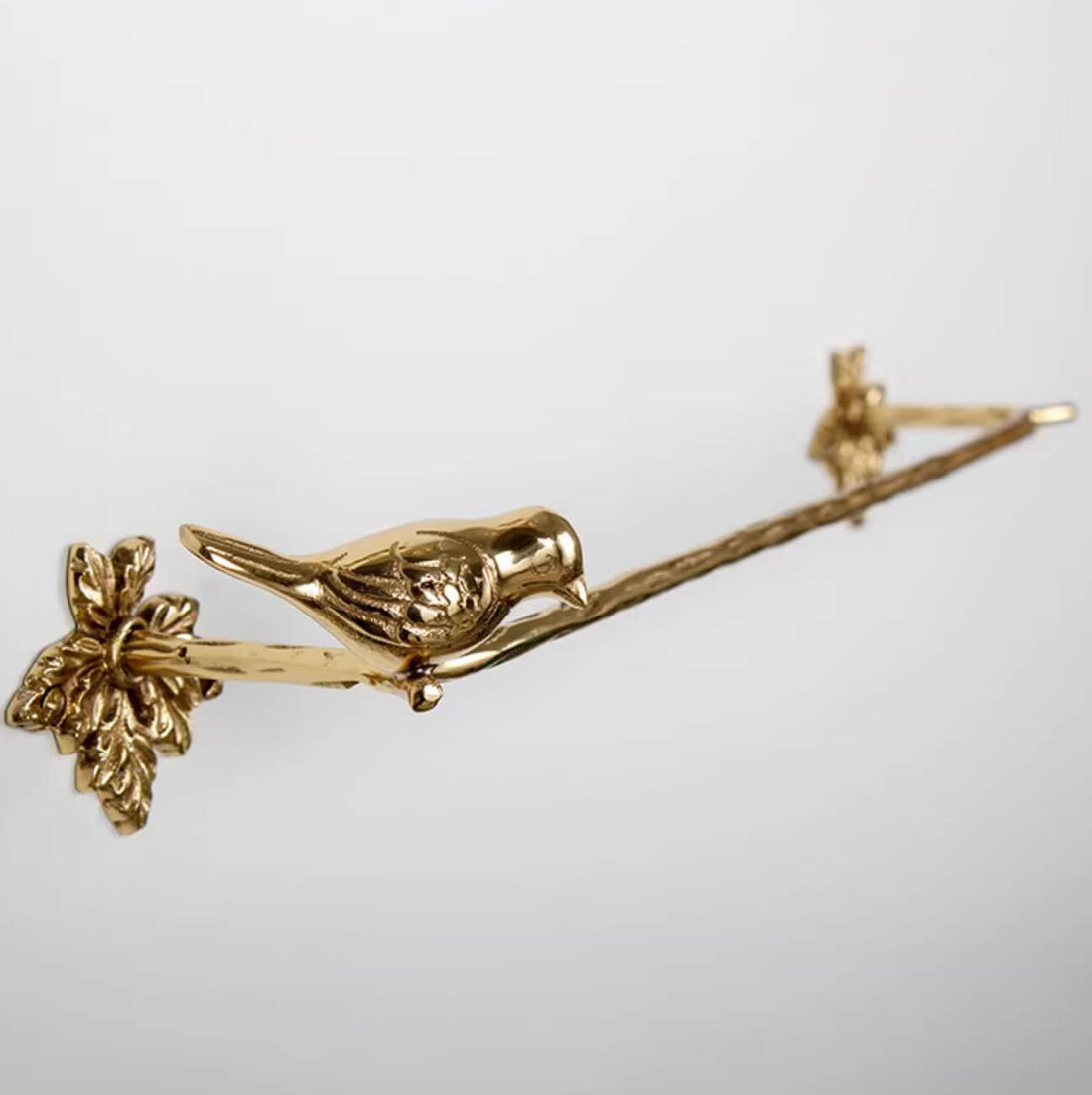 Polished brass bird on branch towel rack from the Brass Bird Bathroom Set.