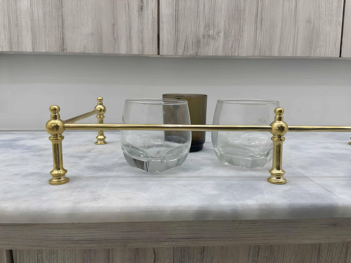 Victorian Brass Gallery Rail - Polished Brass, on marble countertop with glasses