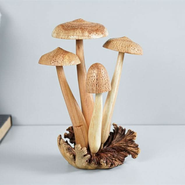 Hand-carved wooden mushroom sculpture with natural wood tones and textured caps, resting on a rustic base.