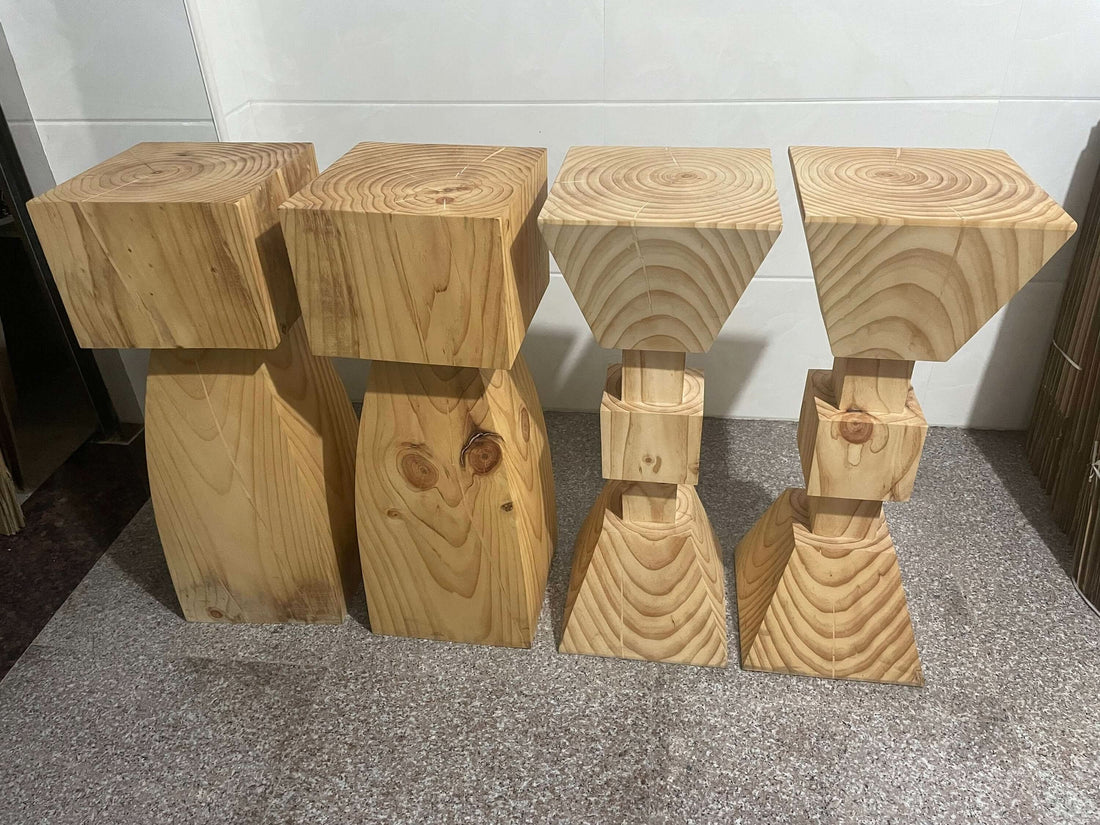 Set of 4 solid wood kitchen stools with unique grain patterns on a speckled floor.