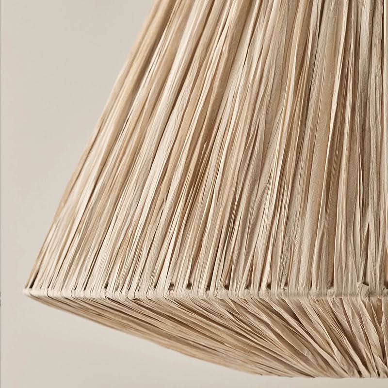 Natural raffia lampshade in a tapered triangular shape, perfect home decor accent.
