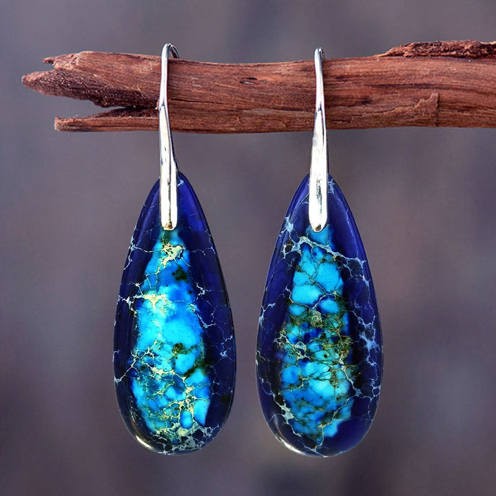 Blue Tear Drop Earrings with intricate blue and turquoise stone patterns and silver hooks.