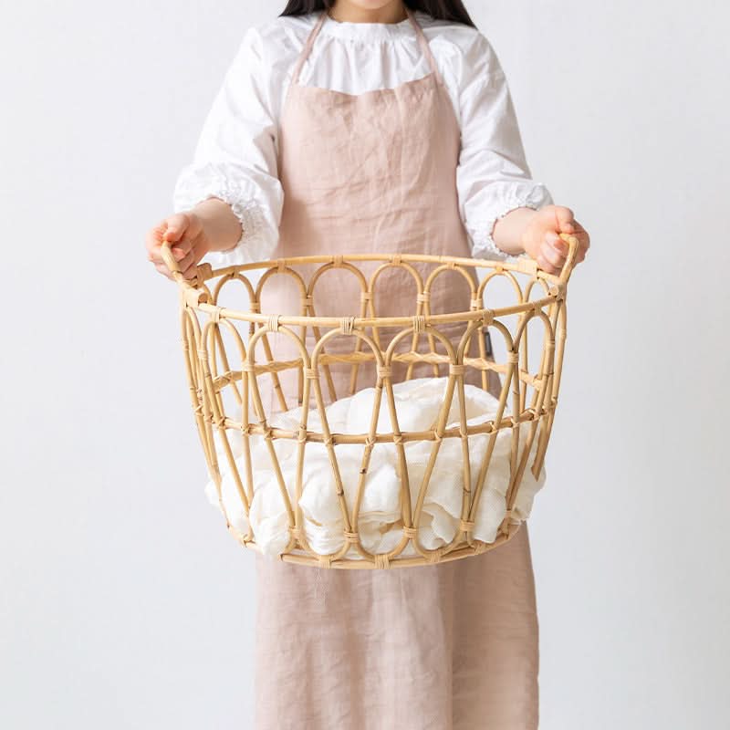 Rattan Round Storage Basket Zig Zag Pattern with white linens.