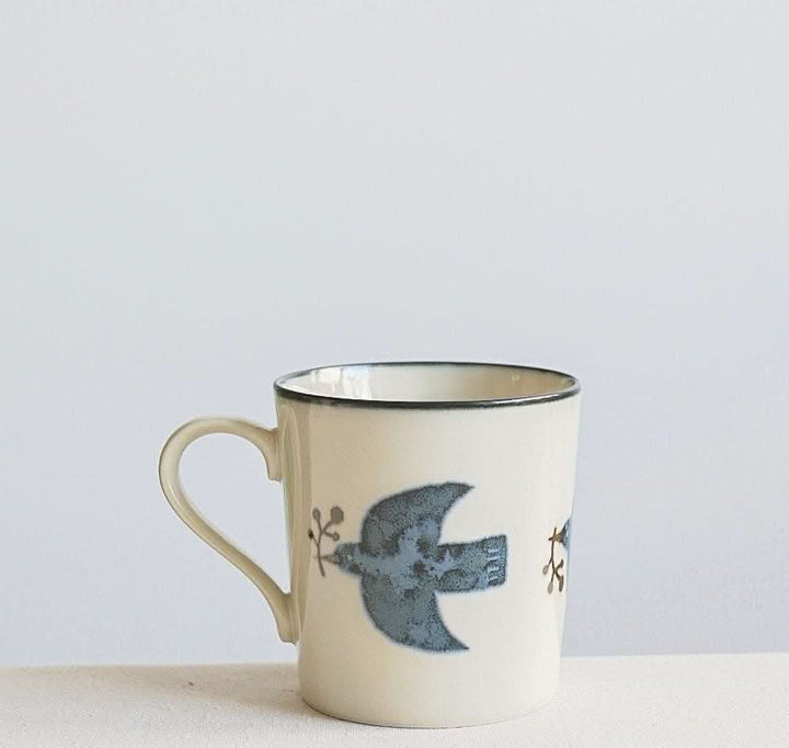 Cream Mino Yaki pottery mug with blue bird handpainting. Home Decor.