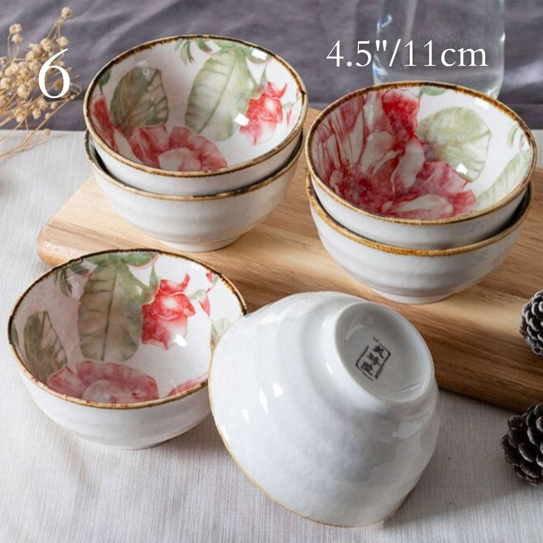 Ceramic glazed 4.5" bowls with Japanese floral illustrations on a wooden board.