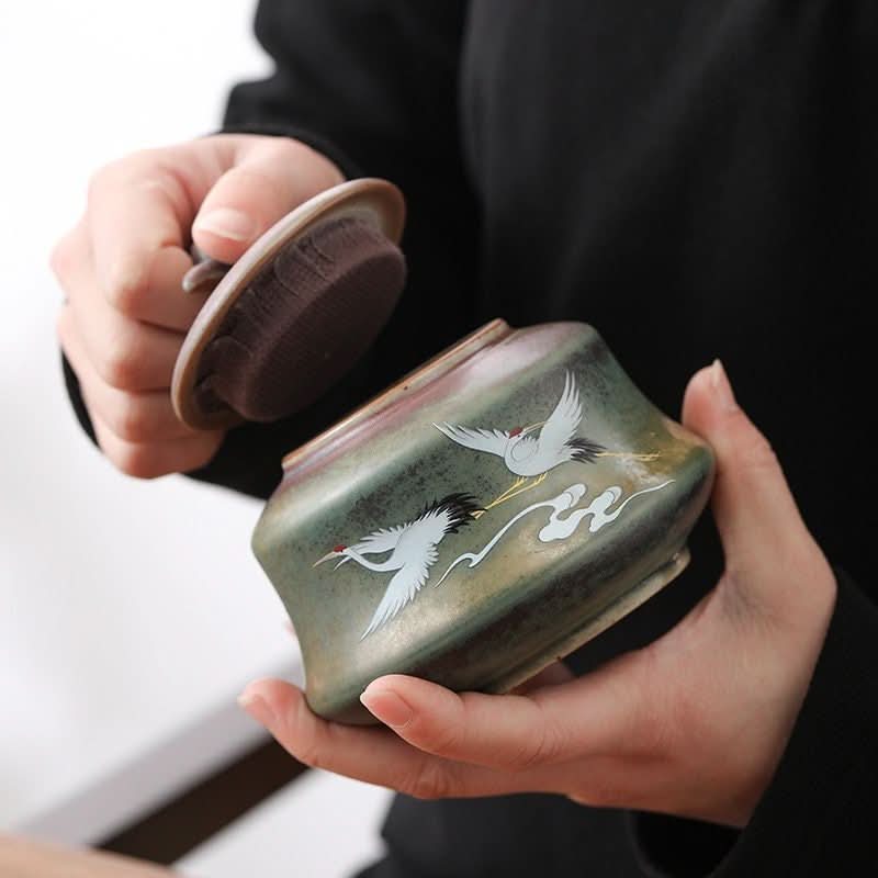 Ceramic tea can with Japanese art illustration, green storage jar with cranes.