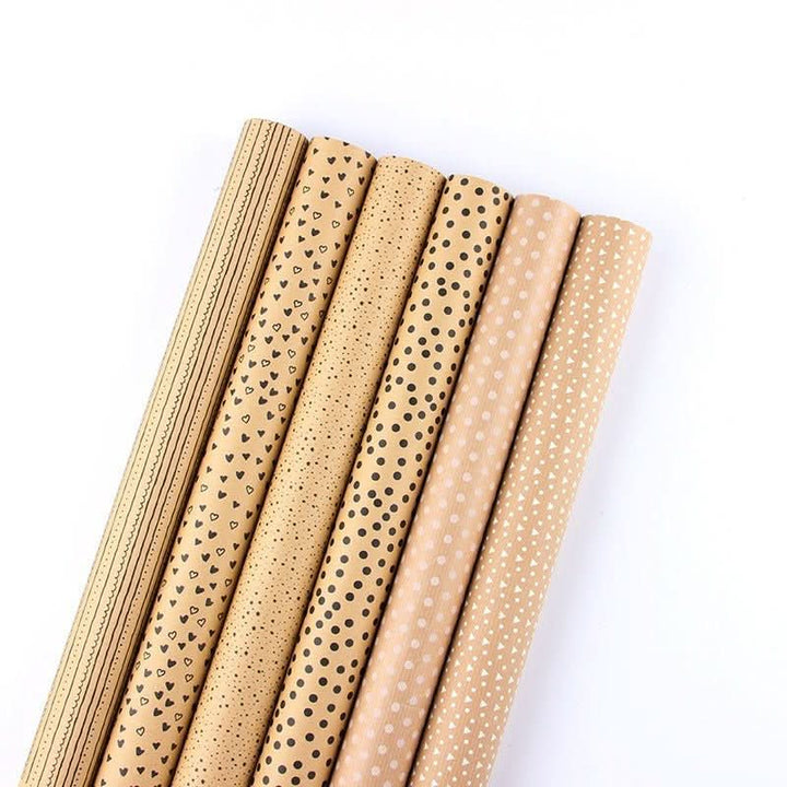 Kraft gift paper rolls with black and white heart, dot, and stripe patterns.