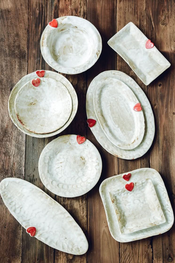 Handcrafted Japanese Love Ceramic Dinner Plates with red hearts on rustic wood table.