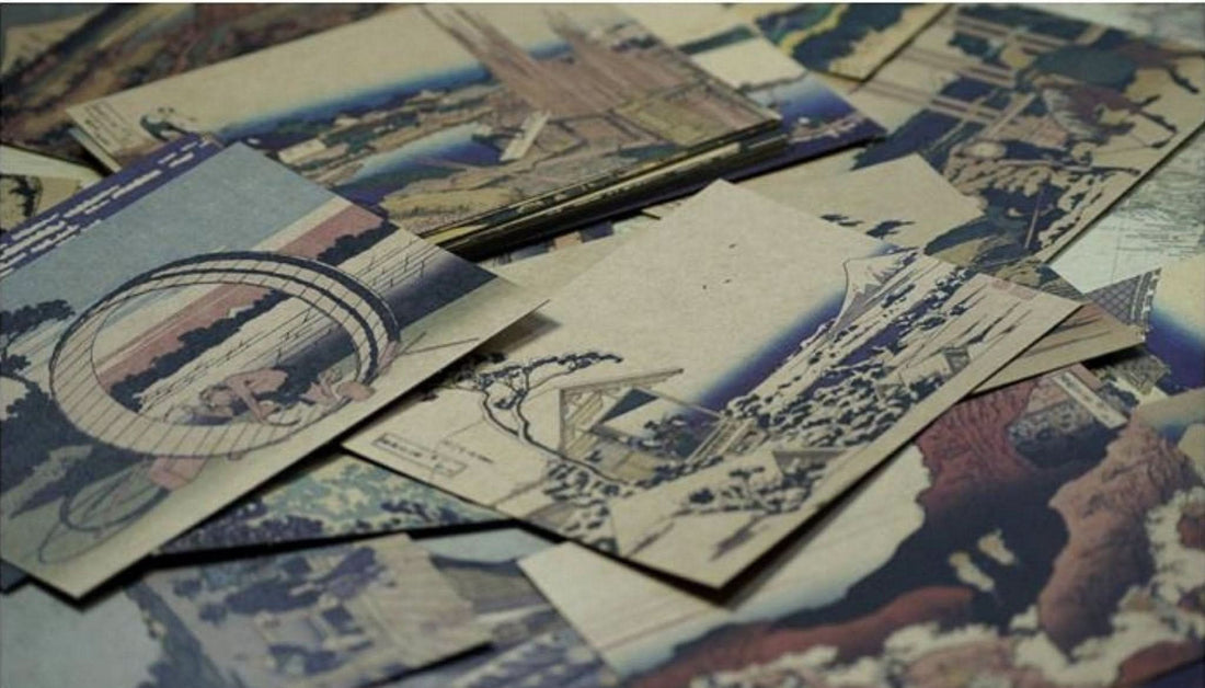 Hokusai Japanese Art Postcards: Ukiyo-e scenes in blue, brown, and earth tones on paper.