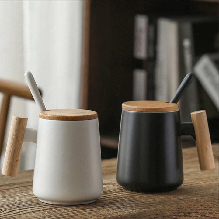 Minimal Japanese style coffee mug, black ceramic with wooden handle and lid.