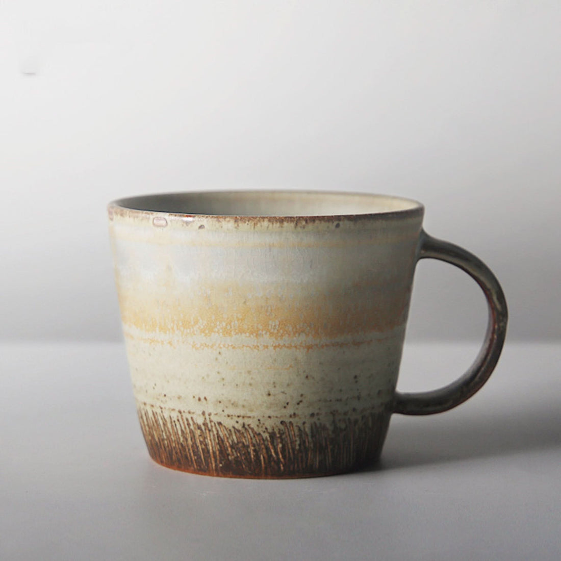 Japanese stoneware mug with carved texture, 10.14oz, cream and brown glaze.