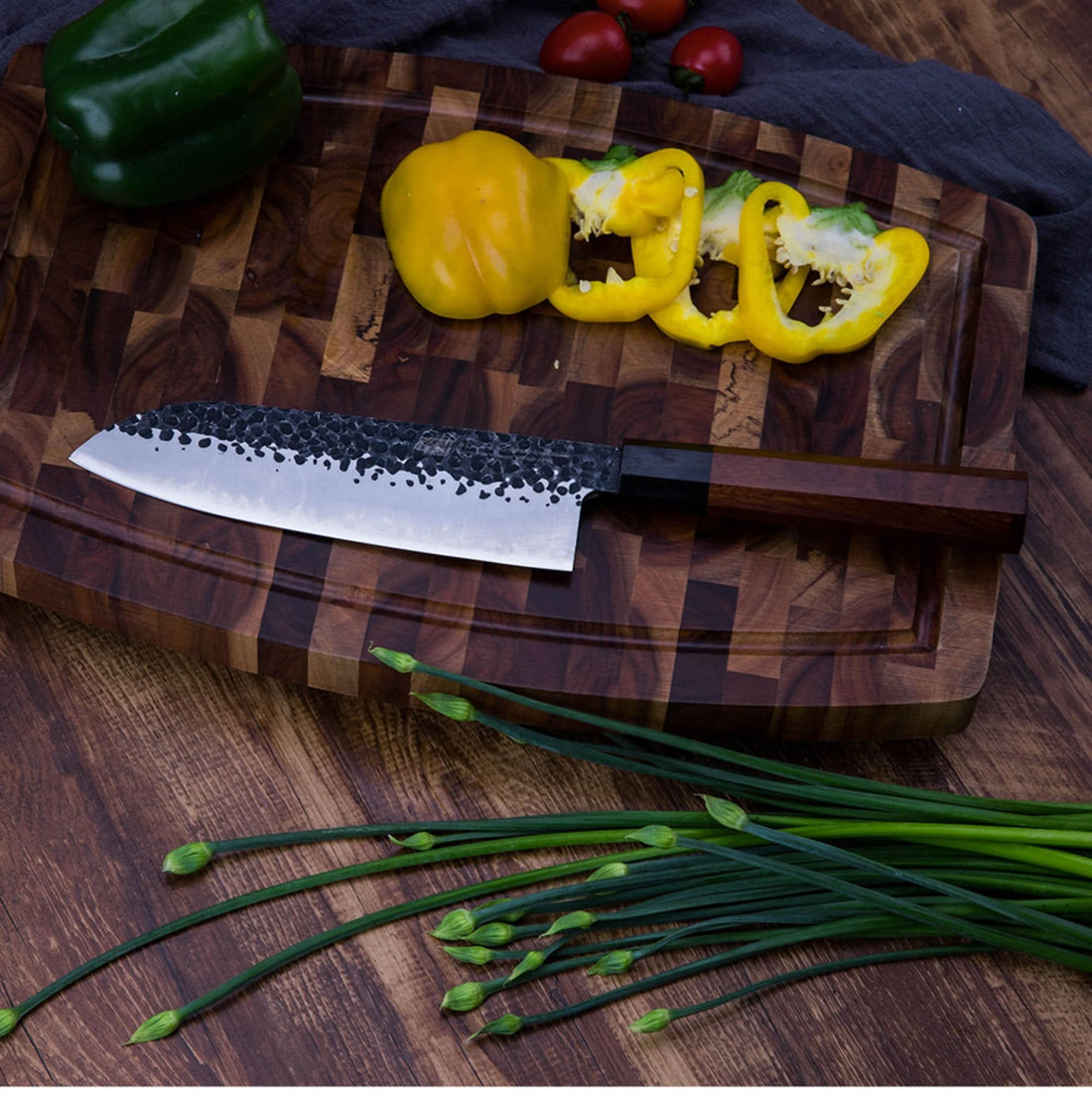 Japanese Forged Knife | Santoku, Kiritsuke, Chef Knife on cutting board with peppers & chives.
