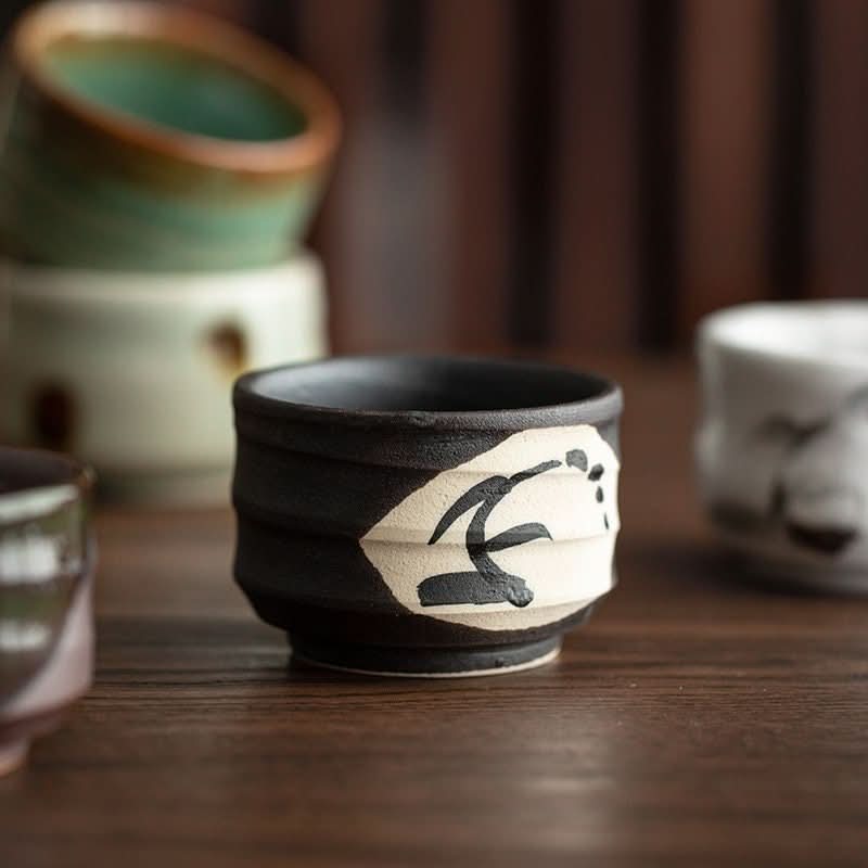 Mino-ware Evening Wind Japanese tea set cups with black & white design on wooden table.