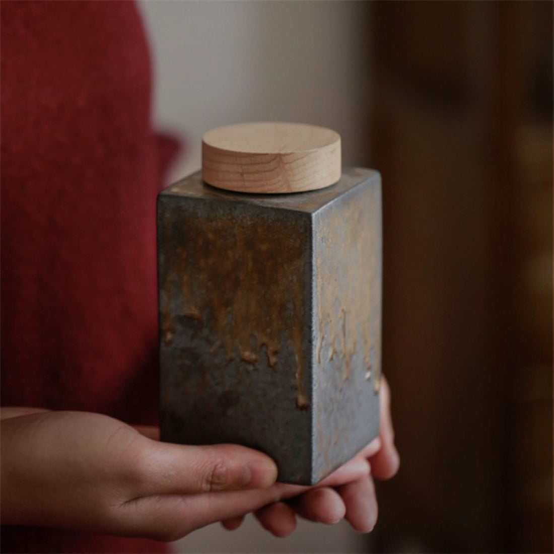 Gray ceramic tea jar with wood lid, rustic home decor.