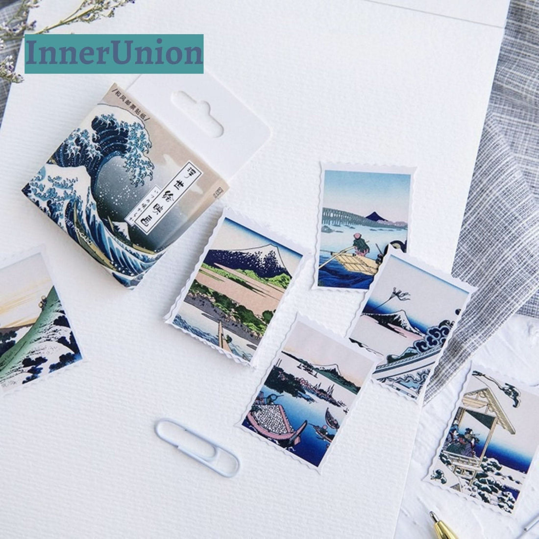Japanese Postcards Stickers showcase Hokusai's art with blue, green, and pink hues on paper.