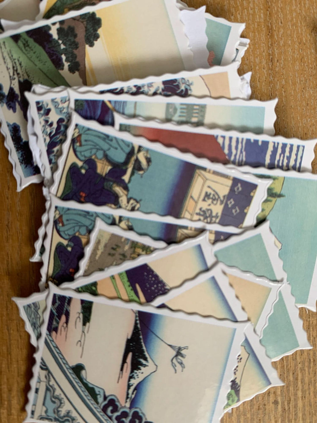 Japanese Postcards Stickers featuring Hokusai Ukiyo-E art, with vibrant colors on a wooden surface.