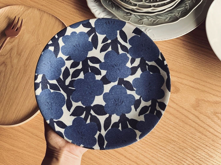 Blue floral Matisse inspired stoneware plate on a wooden table