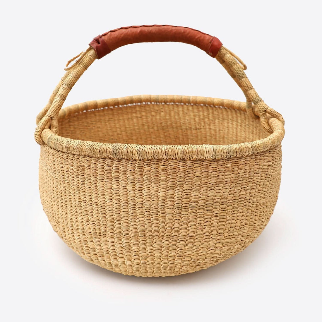 Natural raffia wool woven storage basket dirty laundry with leather handle on white background.