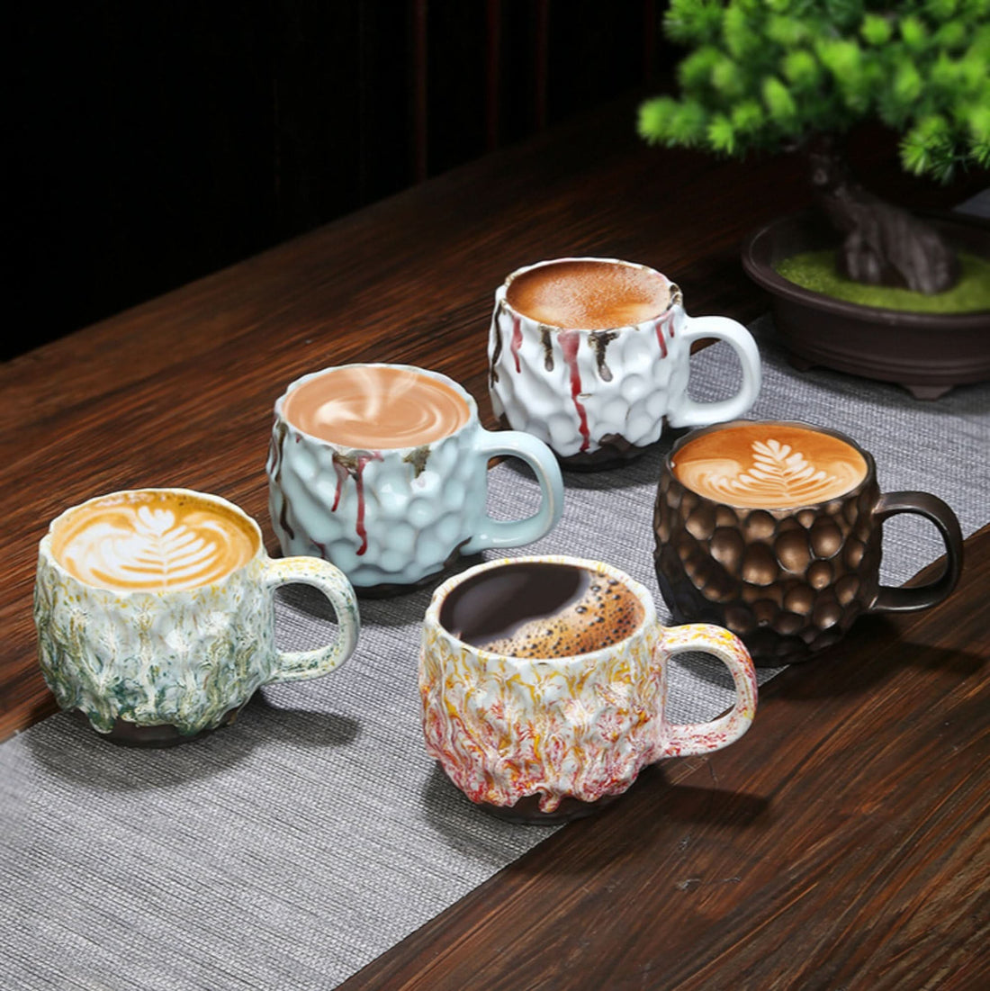 Retro handmade stoneware coffee cups with reactive glaze paint-drip. Colourful pottery mugs.