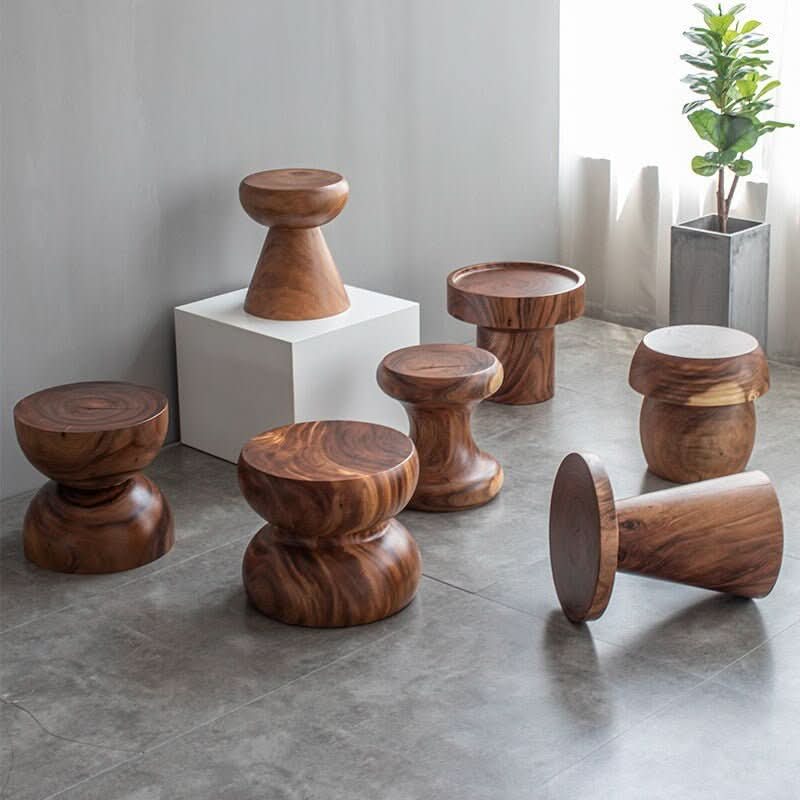 South American Walnut Solid Wood Stools in various modern shapes on a grey floor.