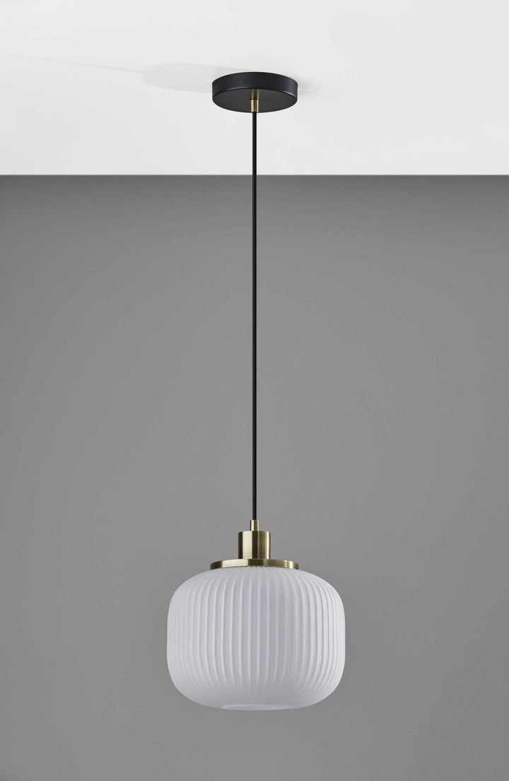Striped Glass Glow Metal Pendant with brass fitting and black ceiling rose, illuminated.