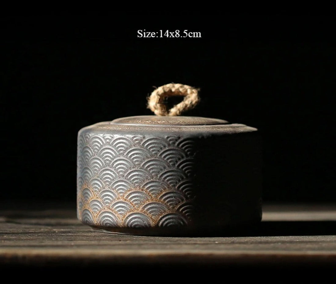 Vintage Japanese tea jar in dark grey ceramic with a scalloped pattern and rope handle.