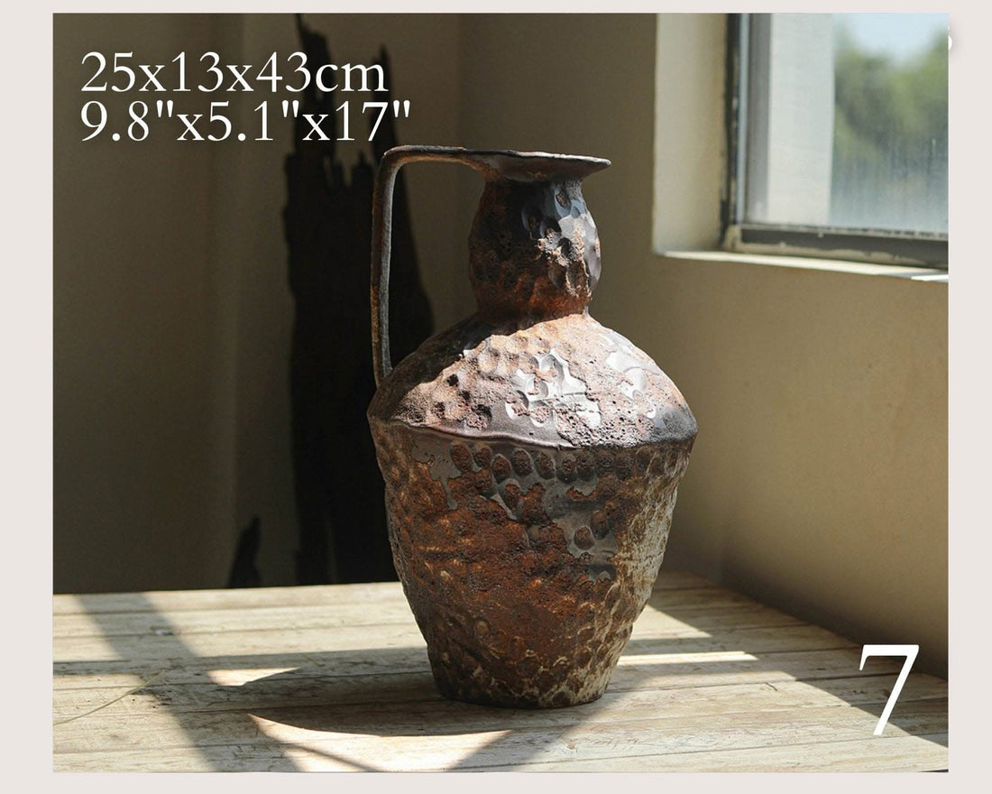 Wabi-Sabi Distressed Rustic Vase: Textured brown ceramic with a handle, on a wooden surface.