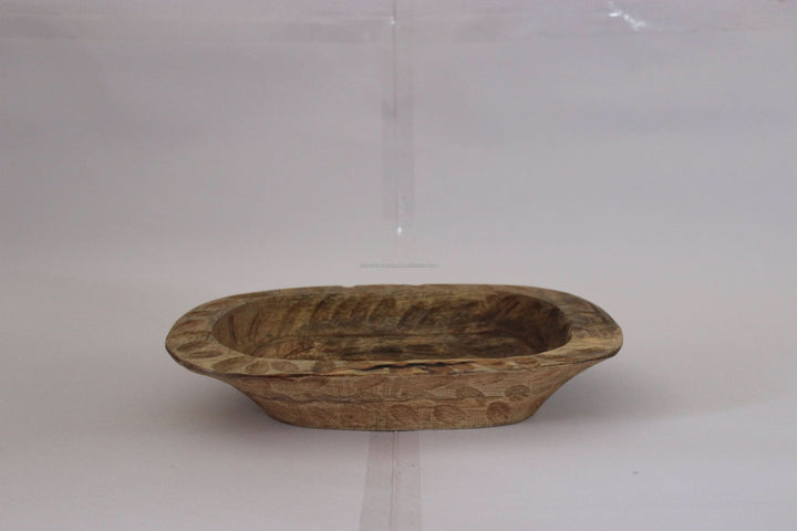 Rustic wood decorative bowl with carved details, ideal for home decor.