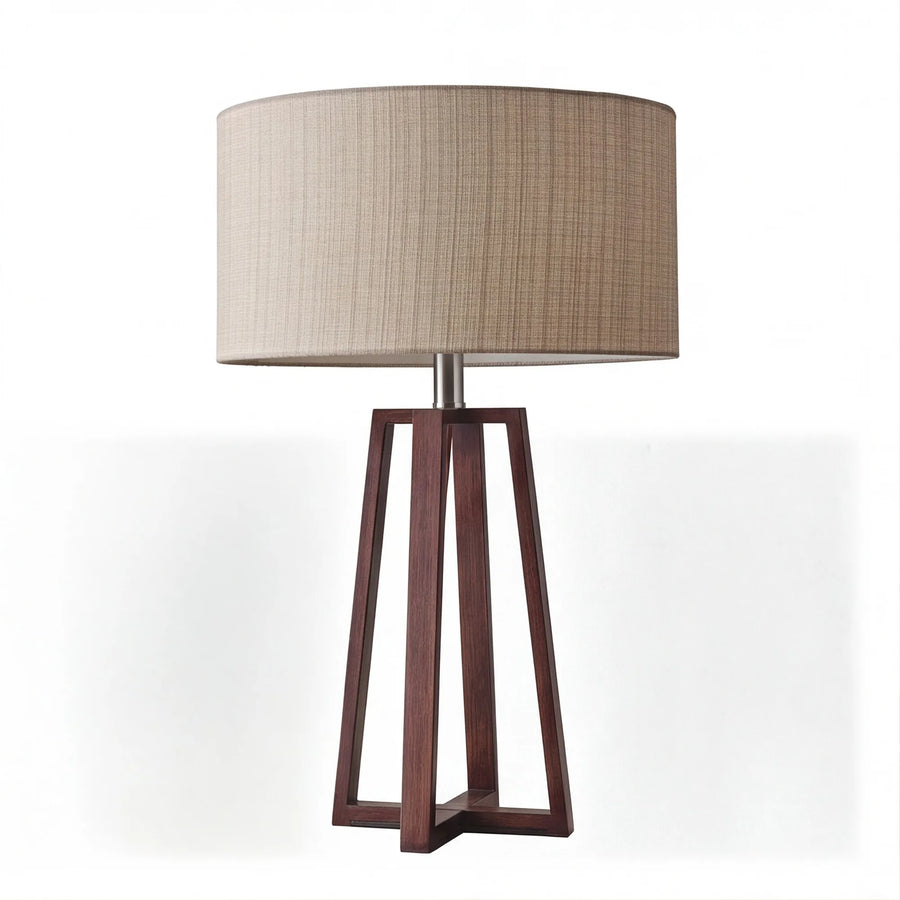 Walnut wood and beige linen drum shade table lamp on white background, lamp off, slatted wood base