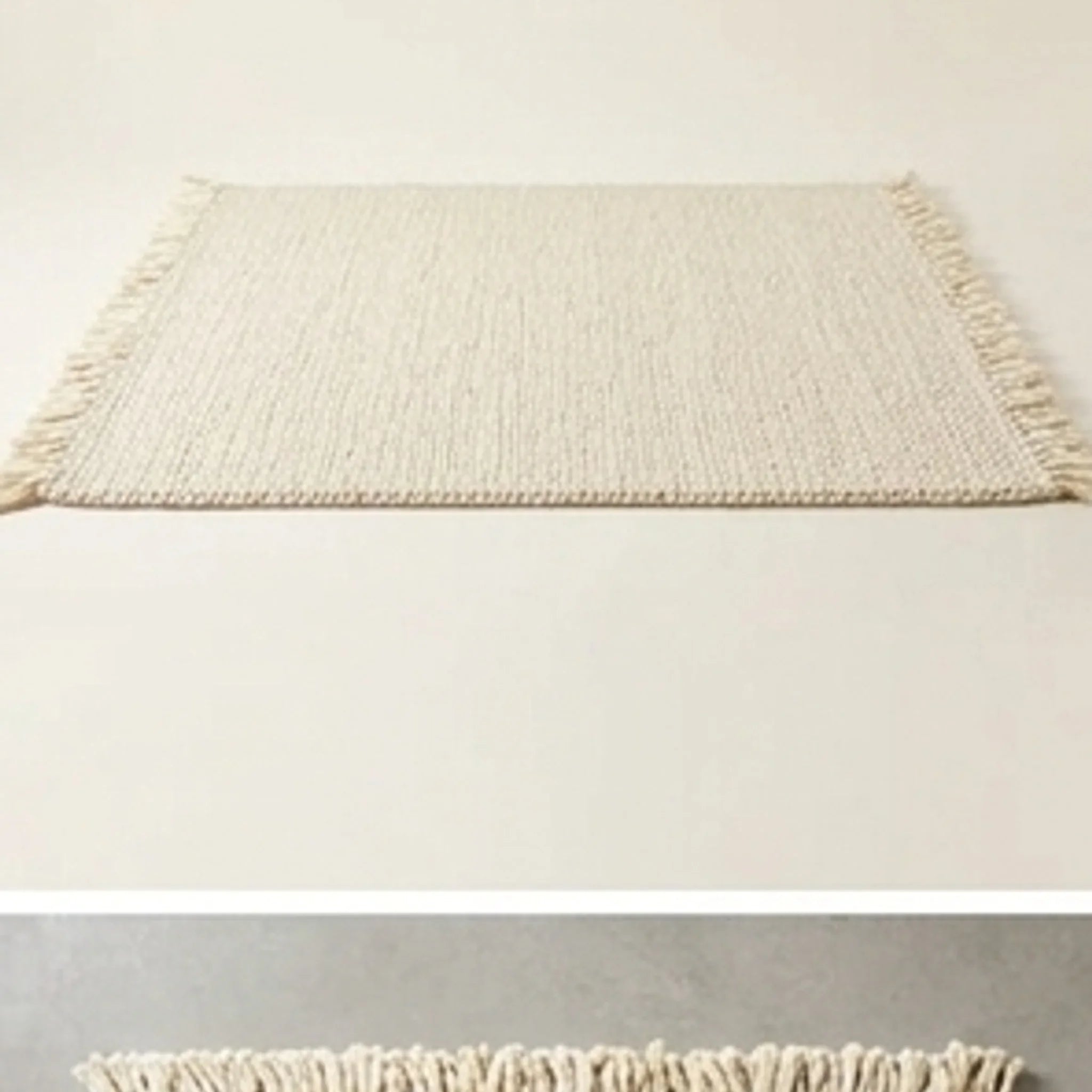 Braided Wool Rug — studio warm-white background product shot