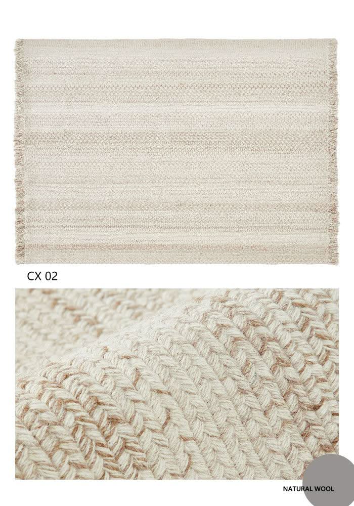 Round wool braided rug in natural tones with fringe. Close-up shows braided texture.