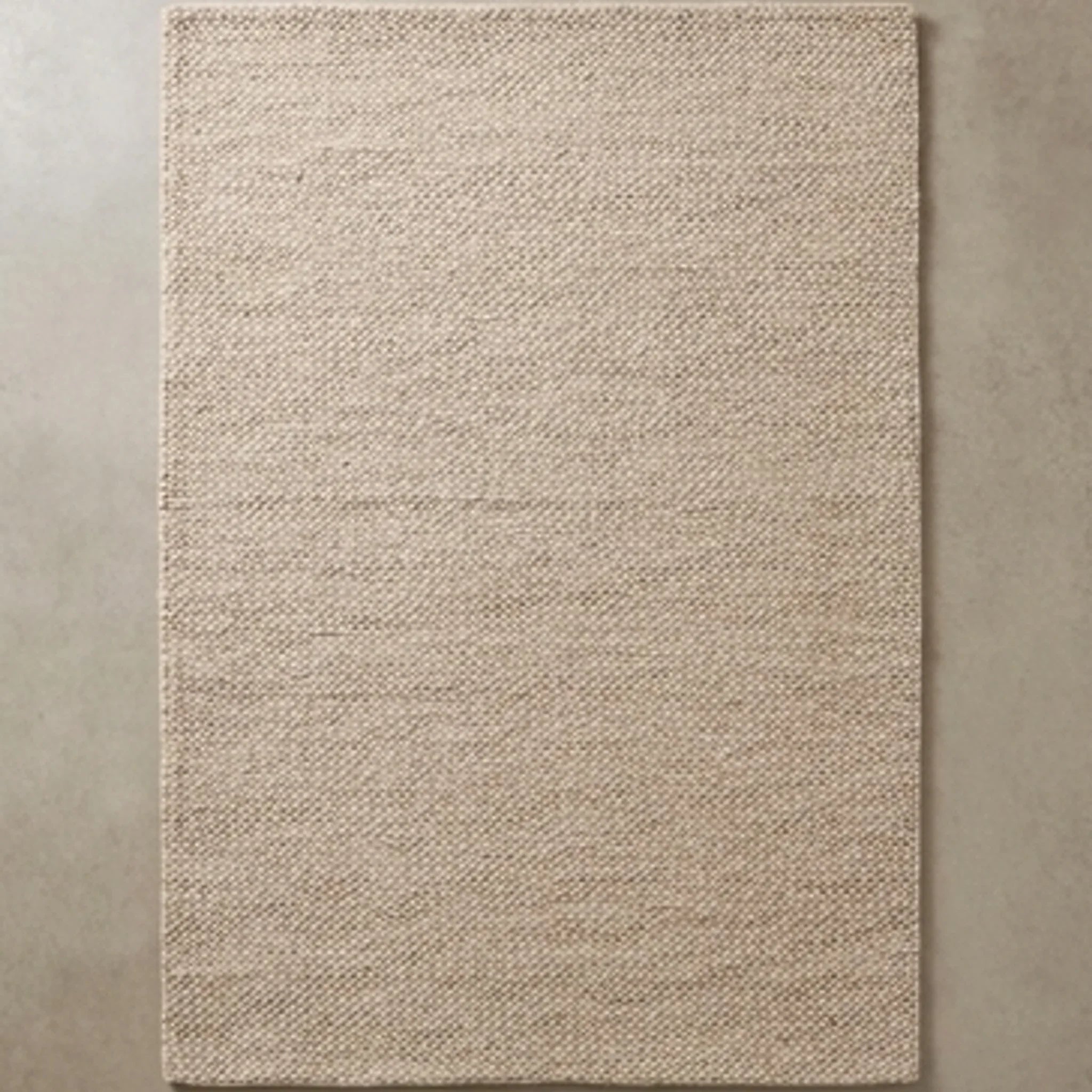 Natural Handwoven New Zealand Wool Rug — overhead flat-lay on a natural surface