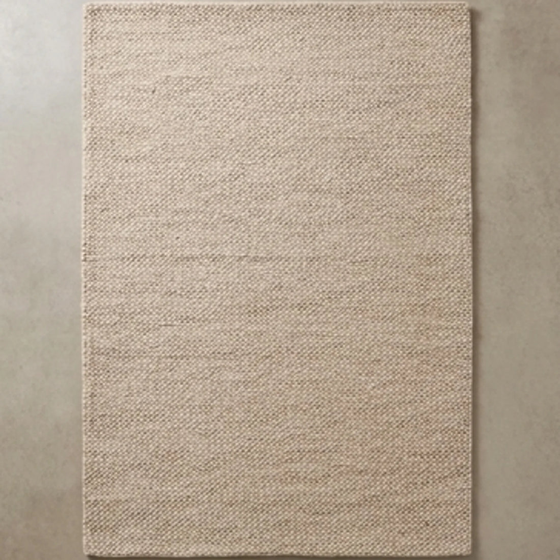 Natural Handwoven New Zealand Wool Rug — overhead flat-lay on a natural surface