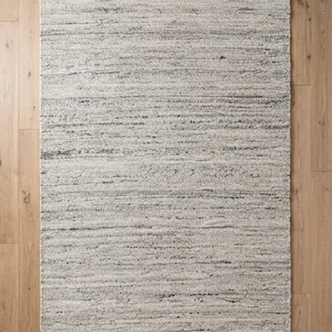 Natural Wool Carpet — overhead flat-lay on a natural surface