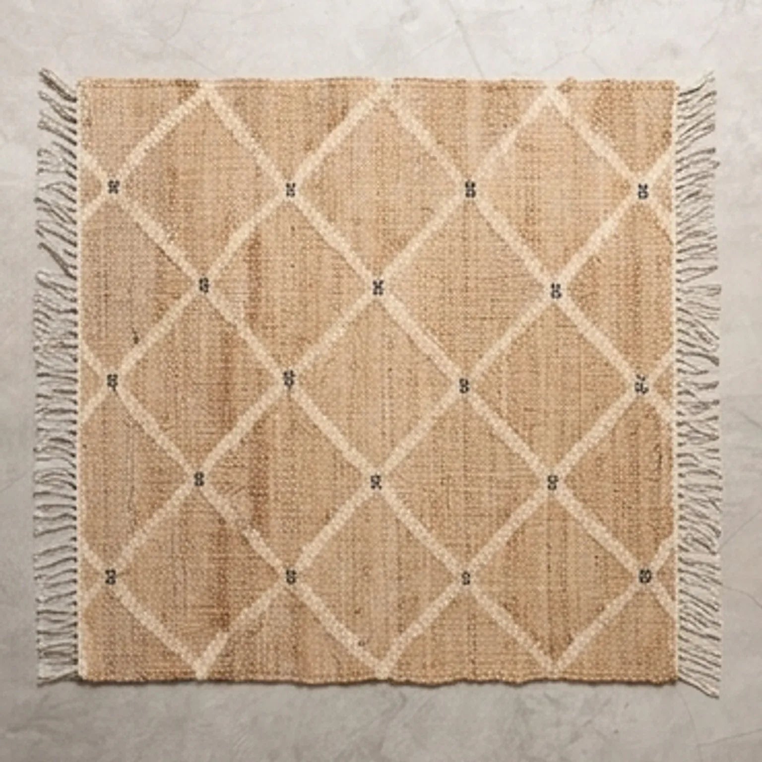 Indian Jute Rug - Beige Diamond Pattern — overhead flat-lay on a natural surface
