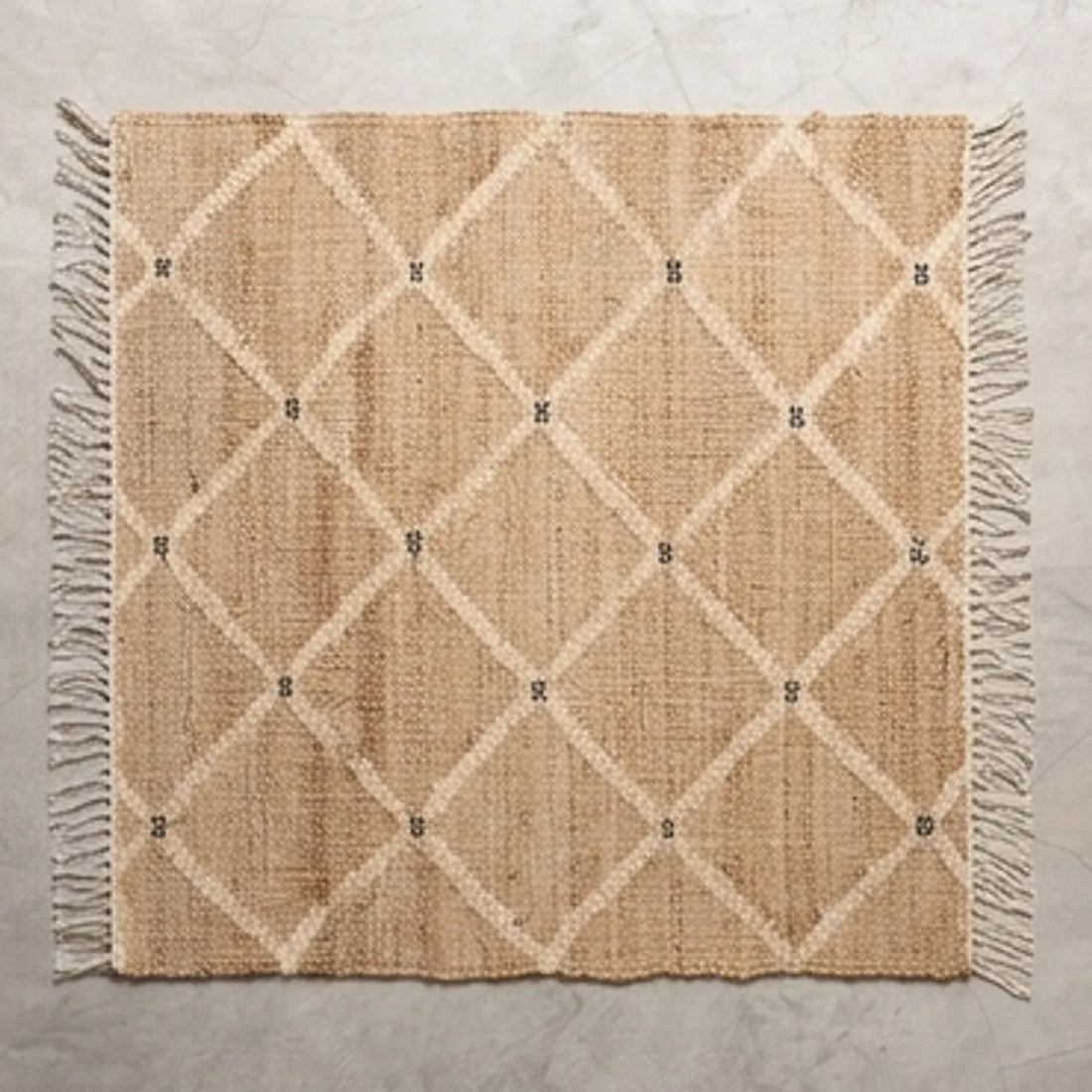 Indian Jute Rug - Beige Diamond Pattern — overhead flat-lay on a natural surface