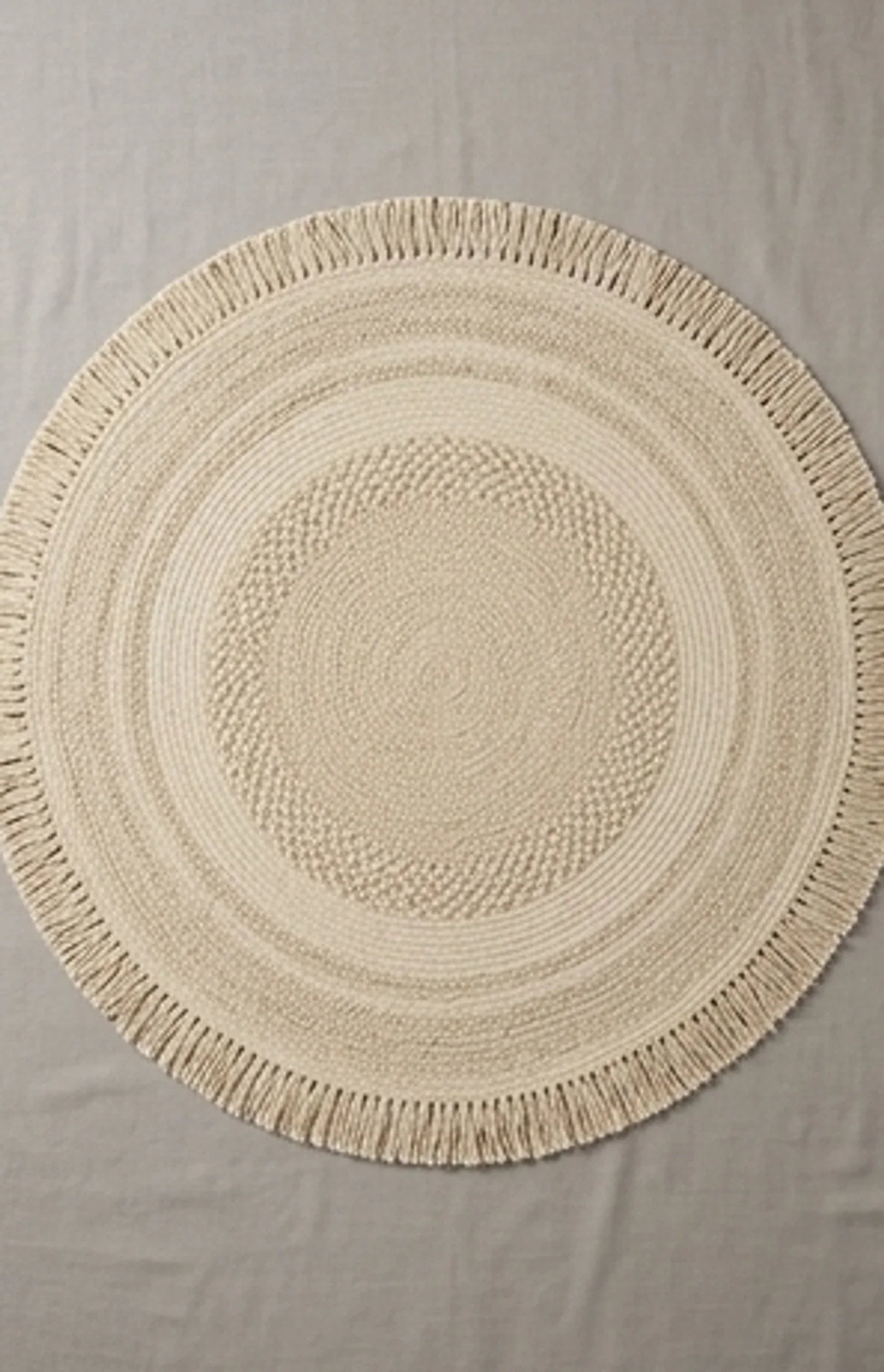 Round Wool Braided Rug — overhead flat-lay on a natural surface