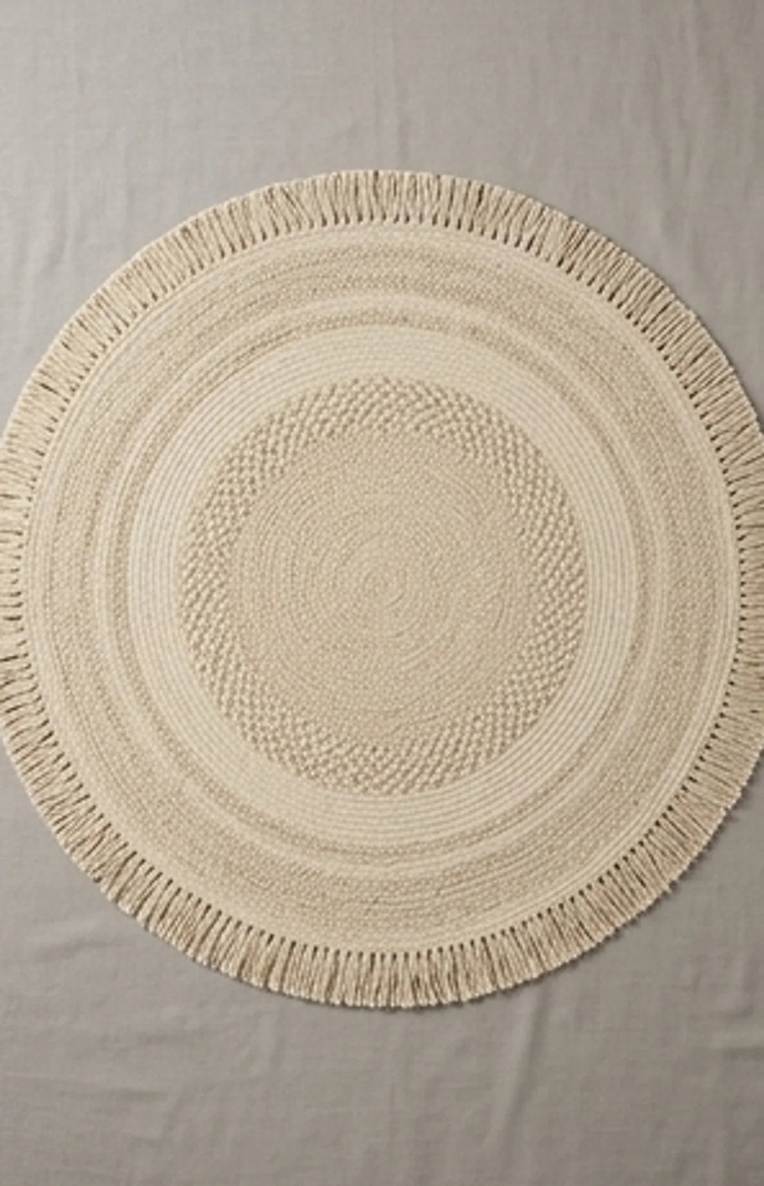 Round Wool Braided Rug — overhead flat-lay on a natural surface