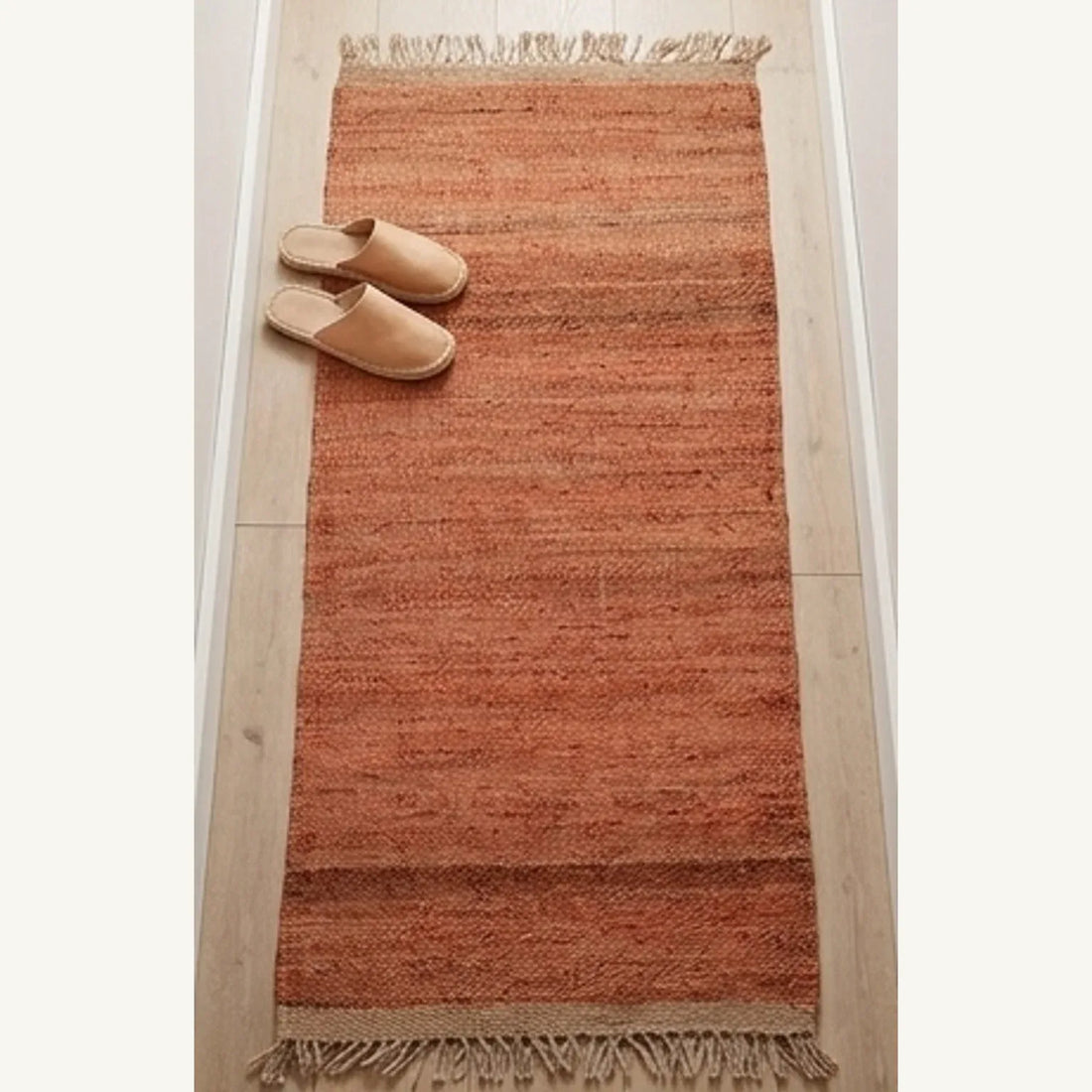 Handwoven Jute Rug - Natural & Rustic — scale reference beside a complementary prop