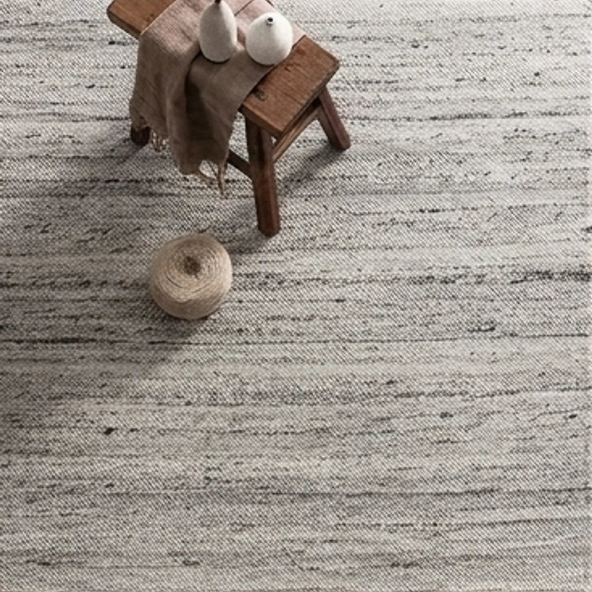 Natural Wool Carpet — scale reference beside a complementary prop